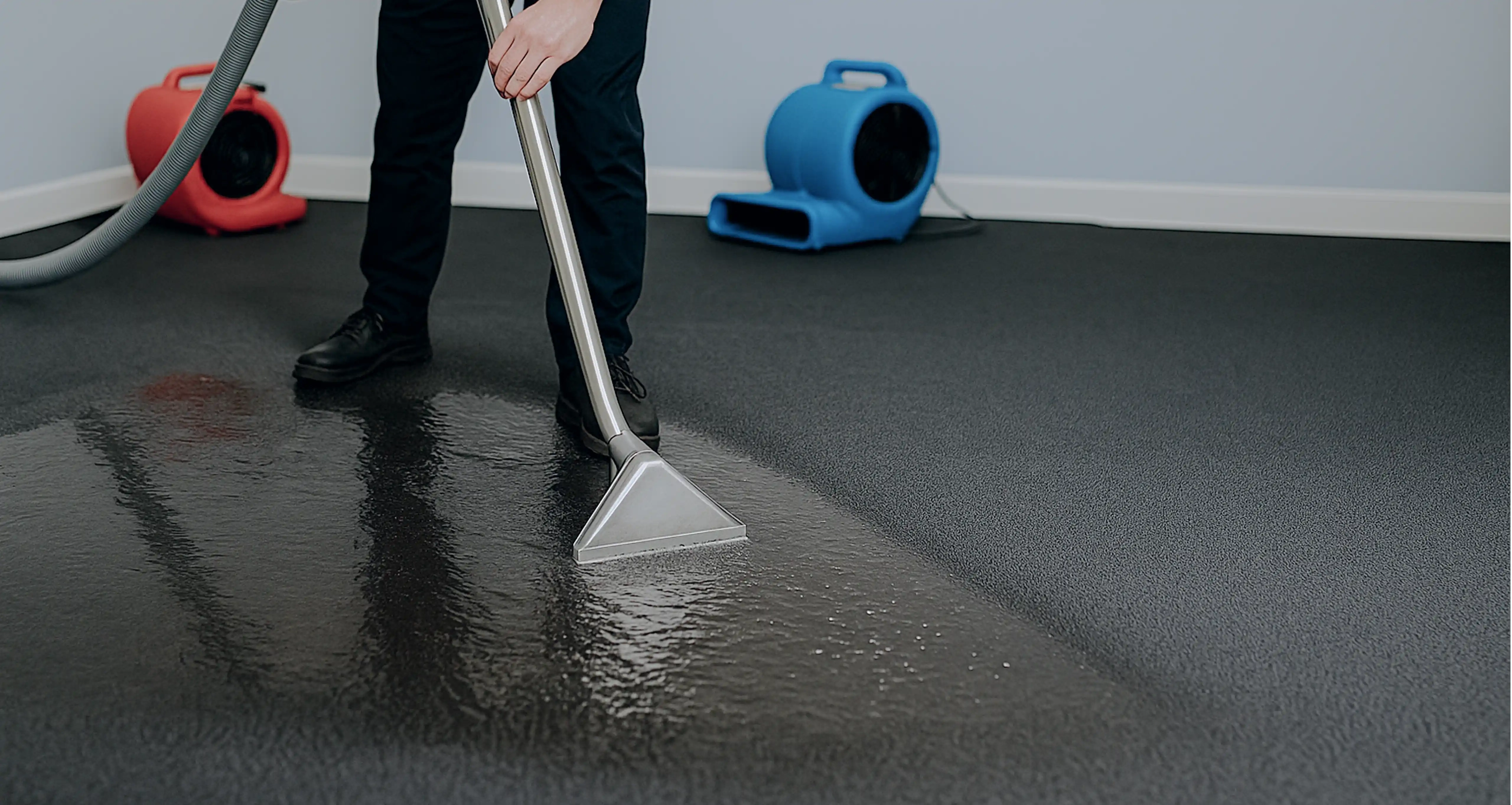 FloodAssist Technician Sucking Water and Drying Wet Carpets